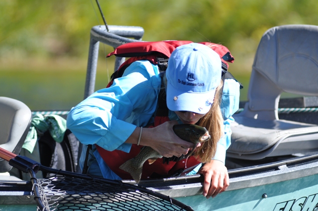 Photo of a fish being kissed before being released back into the Green River